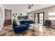 Comfortable living room with plush blue seating, leading to a bright kitchen view at 7384 Valhalla Ln, Las Vegas, NV 89123