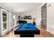 Relaxing living room featuring a bright billiard table and hardwood floors at 7384 Valhalla Ln, Las Vegas, NV 89123