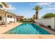 Enjoy this luxurious swimming pool with a tanning ledge, and a perfectly placed palm tree at 7384 Valhalla Ln, Las Vegas, NV 89123