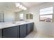 Bathroom featuring a double vanity and large mirrors with natural light at 756 Sleeping City Ave, Henderson, NV 89015