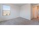Bedroom with neutral carpet, window, and adjacent doorway at 756 Sleeping City Ave, Henderson, NV 89015