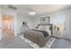 Staged main bedroom features comfortable bed, dresser, and decorative art at 756 Sleeping City Ave, Henderson, NV 89015