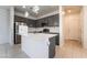 Stylish kitchen boasts stainless steel appliances, gray cabinets, a center island, and modern lighting fixtures at 756 Sleeping City Ave, Henderson, NV 89015