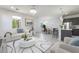 Cozy, furnished living room and dining area with modern decor, bright lighting and an open floor plan at 756 Sleeping City Ave, Henderson, NV 89015