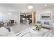 Bright, open-concept living room flows into the kitchen with white tile floors and recessed lighting at 756 Sleeping City Ave, Henderson, NV 89015