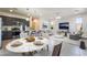 Open-concept living room and kitchen with stainless appliances, stylish lighting, and an open floor plan at 756 Sleeping City Ave, Henderson, NV 89015