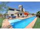 Resort-style backyard with a long pool, tanning chairs, and desert landscaping at 7590 Rancho Destino Rd, Las Vegas, NV 89123