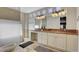 Bathroom with dual sinks, granite countertops, custom cabinetry, and tile flooring at 7590 Rancho Destino Rd, Las Vegas, NV 89123