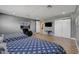 Well-lit bedroom featuring two beds with stylish blue patterned bedspreads and a comfortable armchair at 7590 Rancho Destino Rd, Las Vegas, NV 89123