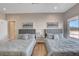 Bedroom featuring two gray upholstered beds and a sliding door with a patio view at 7590 Rancho Destino Rd, Las Vegas, NV 89123