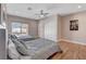 Spacious bedroom featuring two queen beds, hardwood floors, and backyard view at 7590 Rancho Destino Rd, Las Vegas, NV 89123