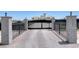Gated driveway leading to an estate, providing privacy and security with landscaped pillars at 7590 Rancho Destino Rd, Las Vegas, NV 89123