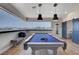Bright game room showcasing a sleek pool table, bench seating and natural light at 7590 Rancho Destino Rd, Las Vegas, NV 89123