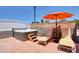 Relaxing hot tub with privacy wall and lounge chairs in a spacious outdoor area at 7590 Rancho Destino Rd, Las Vegas, NV 89123