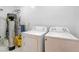 Functional laundry room with white washer and dryer, complemented by essential utility equipment at 7590 Rancho Destino Rd, Las Vegas, NV 89123