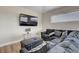 Comfortable living room featuring a plush gray sofa and modern television at 7590 Rancho Destino Rd, Las Vegas, NV 89123
