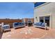 Inviting patio area with stone accents, comfortable seating, and a built-in grill at 7590 Rancho Destino Rd, Las Vegas, NV 89123