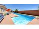In-ground lap pool with lounge chairs and green grass at 7590 Rancho Destino Rd, Las Vegas, NV 89123