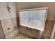 Close-up of shower with tile surround, showerhead, and window at 7590 Rancho Destino Rd, Las Vegas, NV 89123