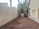 Desert backyard featuring minimal landscaping with palm trees for privacy; rock and wall create a low-maintenance space at 7641 Tortola Bay Ln, Las Vegas, NV 89128