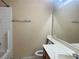 Simple bathroom with a shower-tub combo, a single sink vanity, and a toilet in neutral tones at 7641 Tortola Bay Ln, Las Vegas, NV 89128