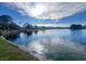 Picturesque view of the lake featuring a lush shoreline and serene atmosphere at 7641 Tortola Bay Ln, Las Vegas, NV 89128