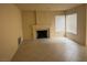 Inviting living room with a cozy fireplace and tile flooring at 7641 Tortola Bay Ln, Las Vegas, NV 89128