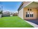 This artificial turf backyard has a block wall and a covered patio for relaxing outdoors at 7816 Calico Flower Ave, Las Vegas, NV 89128