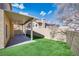 Backyard with covered patio, artificial turf, block walls, perfect for outdoor activities and relaxation at 7816 Calico Flower Ave, Las Vegas, NV 89128