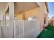 This private backyard has a metal fence, covered patio, artificial turf, and stucco walls at 7816 Calico Flower Ave, Las Vegas, NV 89128