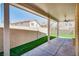 Relax on this covered patio, overlooking the artificial turf lawn and block wall at 7816 Calico Flower Ave, Las Vegas, NV 89128