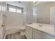 Well-lit bathroom features a shower-over-tub, modern vanity, and bright white tile at 7816 Calico Flower Ave, Las Vegas, NV 89128