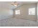 This spacious bedroom features neutral walls, plush carpeting, and bright windows at 7816 Calico Flower Ave, Las Vegas, NV 89128