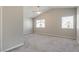 This spacious bedroom features neutral walls, plush carpeting, and bright windows at 7816 Calico Flower Ave, Las Vegas, NV 89128