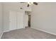 This bedroom features double door closets and neutral colored carpeting at 7816 Calico Flower Ave, Las Vegas, NV 89128