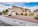 This home has a two car garage, rock landscaping, a green gate, and a stucco exterior at 7816 Calico Flower Ave, Las Vegas, NV 89128