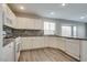 Bright kitchen features white cabinets, stainless steel appliances, and a gray backsplash at 7816 Calico Flower Ave, Las Vegas, NV 89128