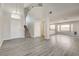 View of open-concept living room with staircase, wood floors, and entry to kitchen at 7816 Calico Flower Ave, Las Vegas, NV 89128