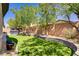 Well-manicured backyard featuring artificial turf and a soothing hot tub for relaxation at 8544 Garden Valley Ct, Las Vegas, NV 89178