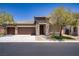 Charming single-story home featuring a stone facade, a three-car garage, and a well-manicured front yard at 8544 Garden Valley Ct, Las Vegas, NV 89178