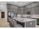 Stylish kitchen with gray cabinets, granite countertops, stainless steel appliances, and a large center island at 8544 Garden Valley Ct, Las Vegas, NV 89178