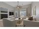 Bright living room featuring a fireplace, stylish furniture, and a ceiling fan at 8544 Garden Valley Ct, Las Vegas, NV 89178