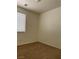 This is a simple bedroom with neutral walls, carpet, and a window with blinds at 8756 Shady Pines Dr, Las Vegas, NV 89143