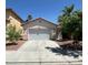 Charming single-story home features a two-car garage, desert landscaping, and a concrete driveway at 8756 Shady Pines Dr, Las Vegas, NV 89143