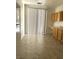 Efficient kitchen featuring wood cabinets, tile floors, and a sliding glass door at 8756 Shady Pines Dr, Las Vegas, NV 89143