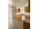 Well-lit kitchen features wood cabinets, tile floors, a modern sink, and lots of counter space at 8756 Shady Pines Dr, Las Vegas, NV 89143