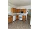 Efficient kitchen with oak cabinets, modern appliances, and tile flooring at 8756 Shady Pines Dr, Las Vegas, NV 89143