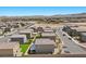 A high-angle view of a neighborhood highlighting manicured lawns and desert landscape at 9054 Tangerine Tree Ct, Las Vegas, NV 89113