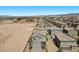 Drone shot showcases the property, neighborhood, and surrounding desert landscape under clear blue sky at 9054 Tangerine Tree Ct, Las Vegas, NV 89113
