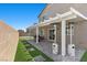 Backyard with a covered patio, manicured lawn, stone features and an elegant patio cover at 9054 Tangerine Tree Ct, Las Vegas, NV 89113